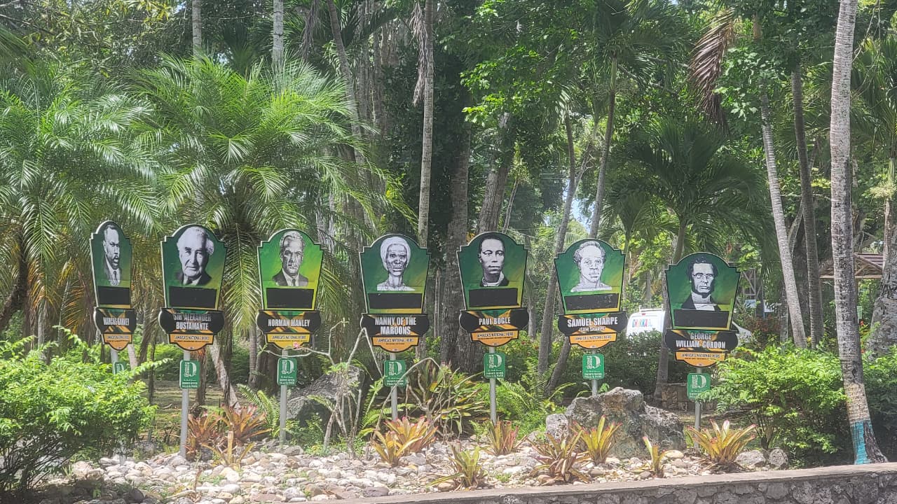 Jamaican national heroes display among tropical trees