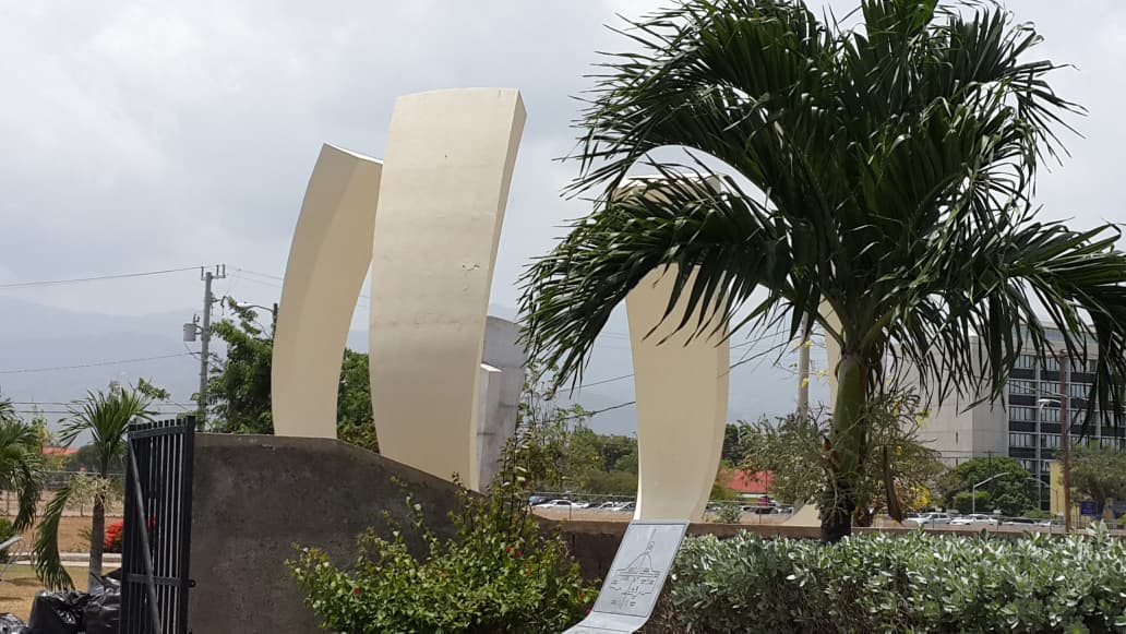 Modern monument surrounded by palm trees